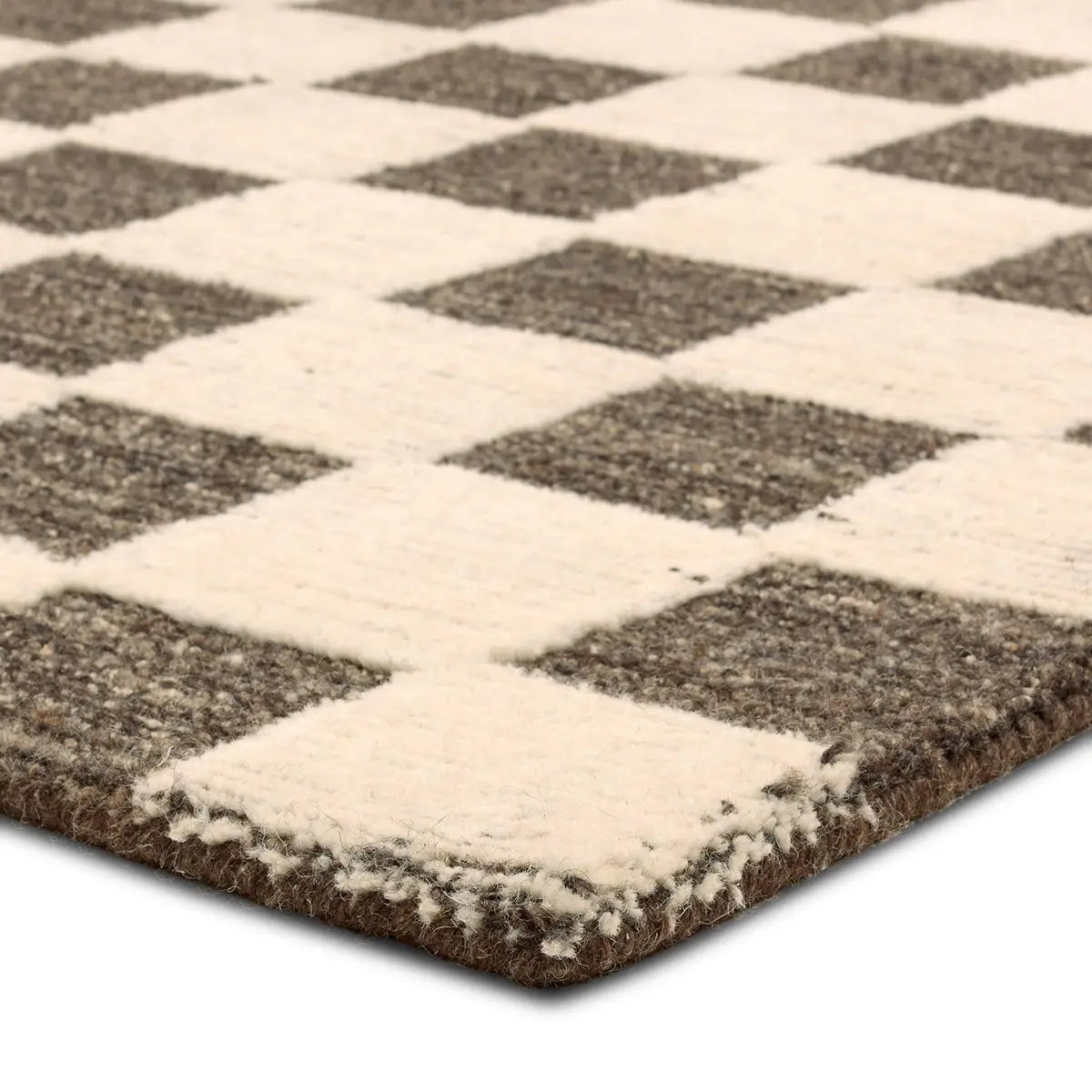 Close-up of a textured rug with a diamond pattern in brown and white.
