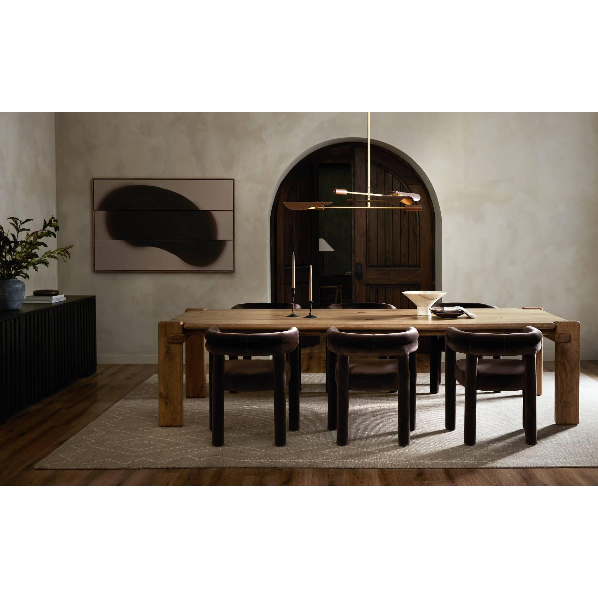 Dining room with wooden table and chairs in a modern interior setting.