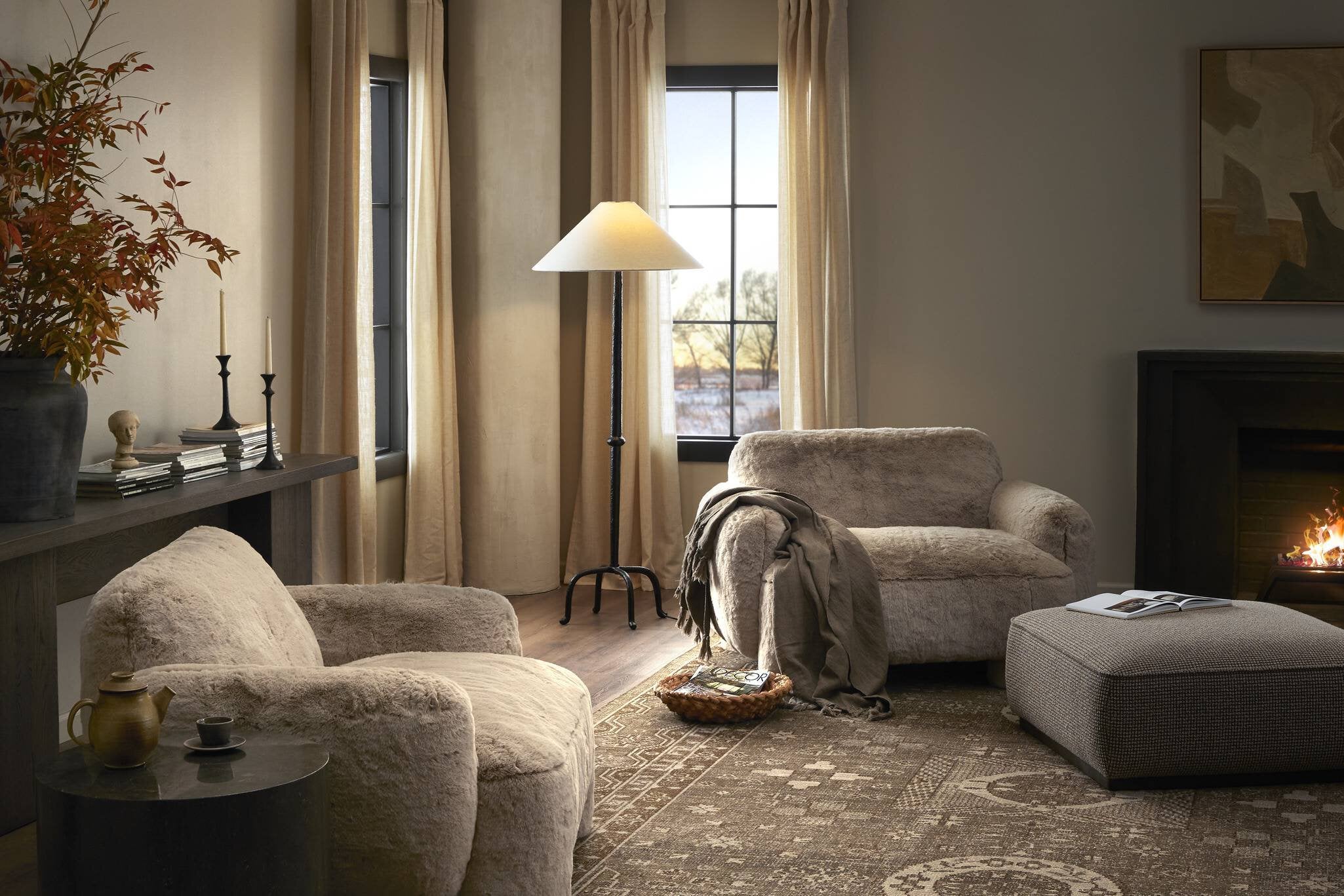 Cozy living room with beige armchairs, a lamp, and decorative items.
