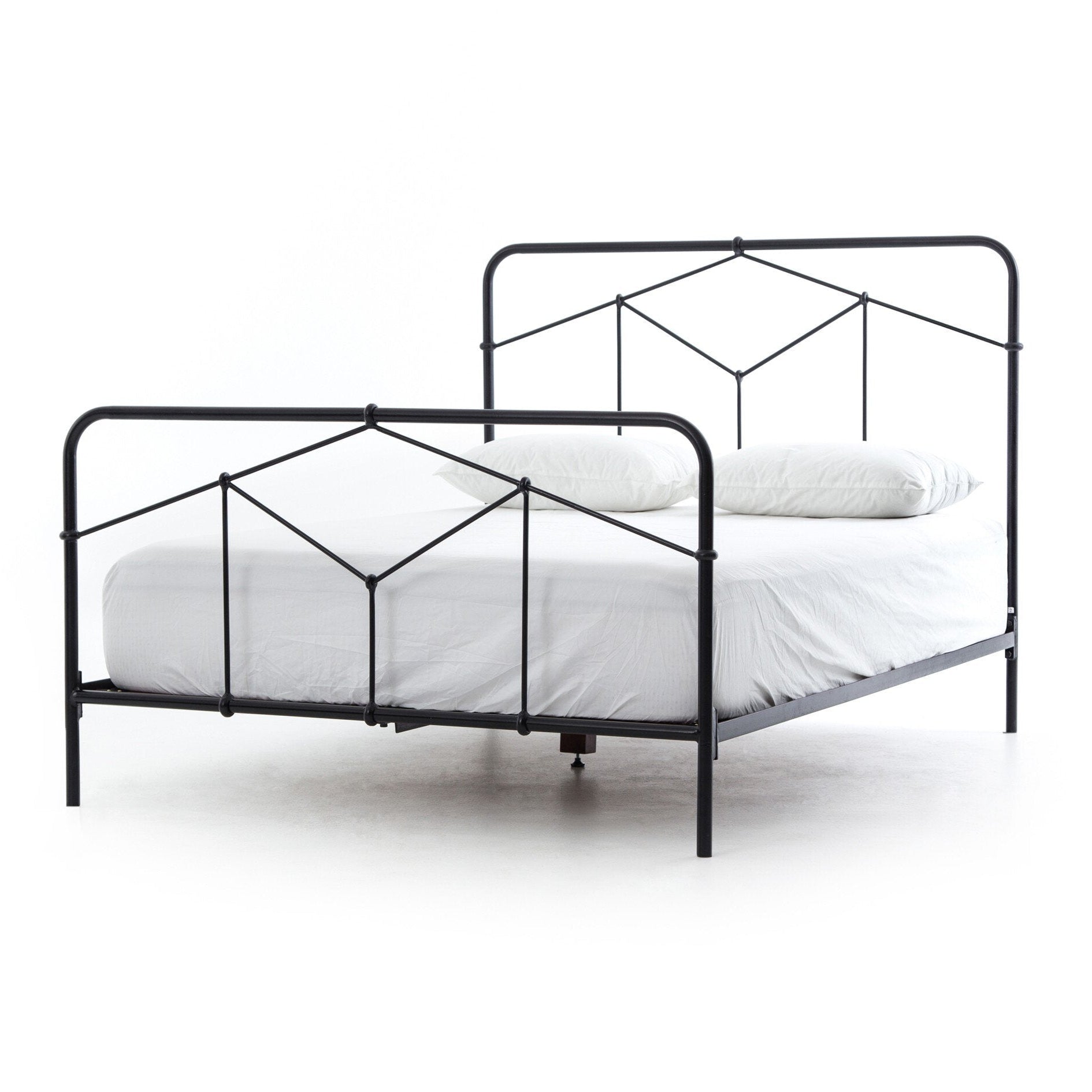 Black metal bed frame with white mattress on a white background