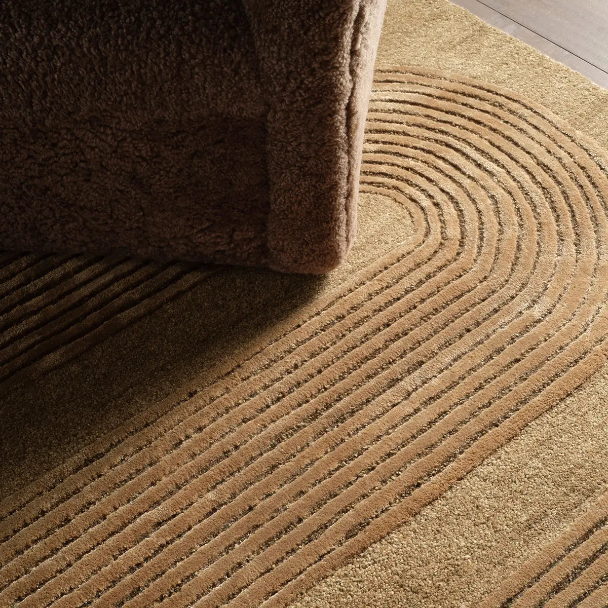 Close-up of a textured brown rug with concentric circle pattern