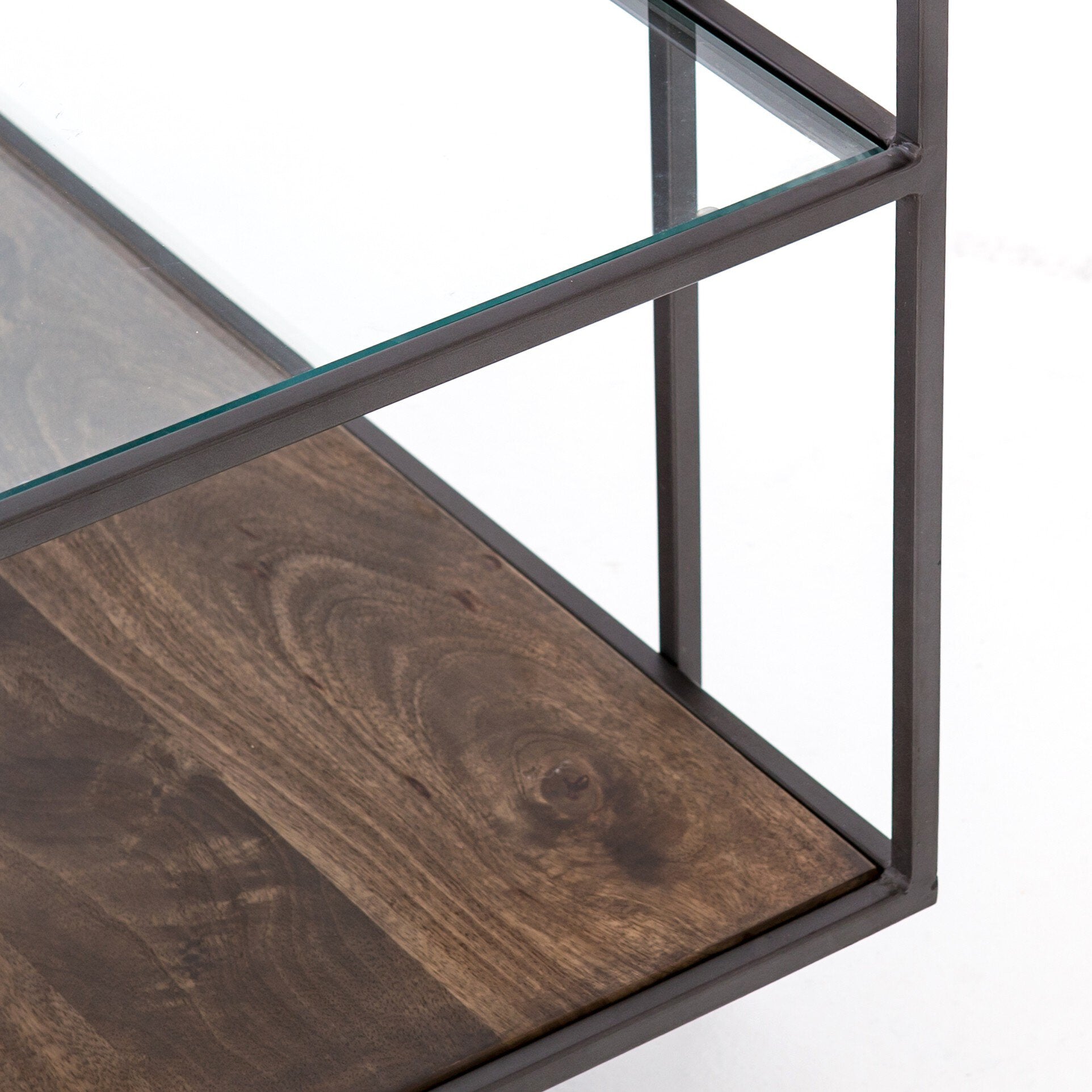 Coffee table with glass top and wooden shelf on a white background
