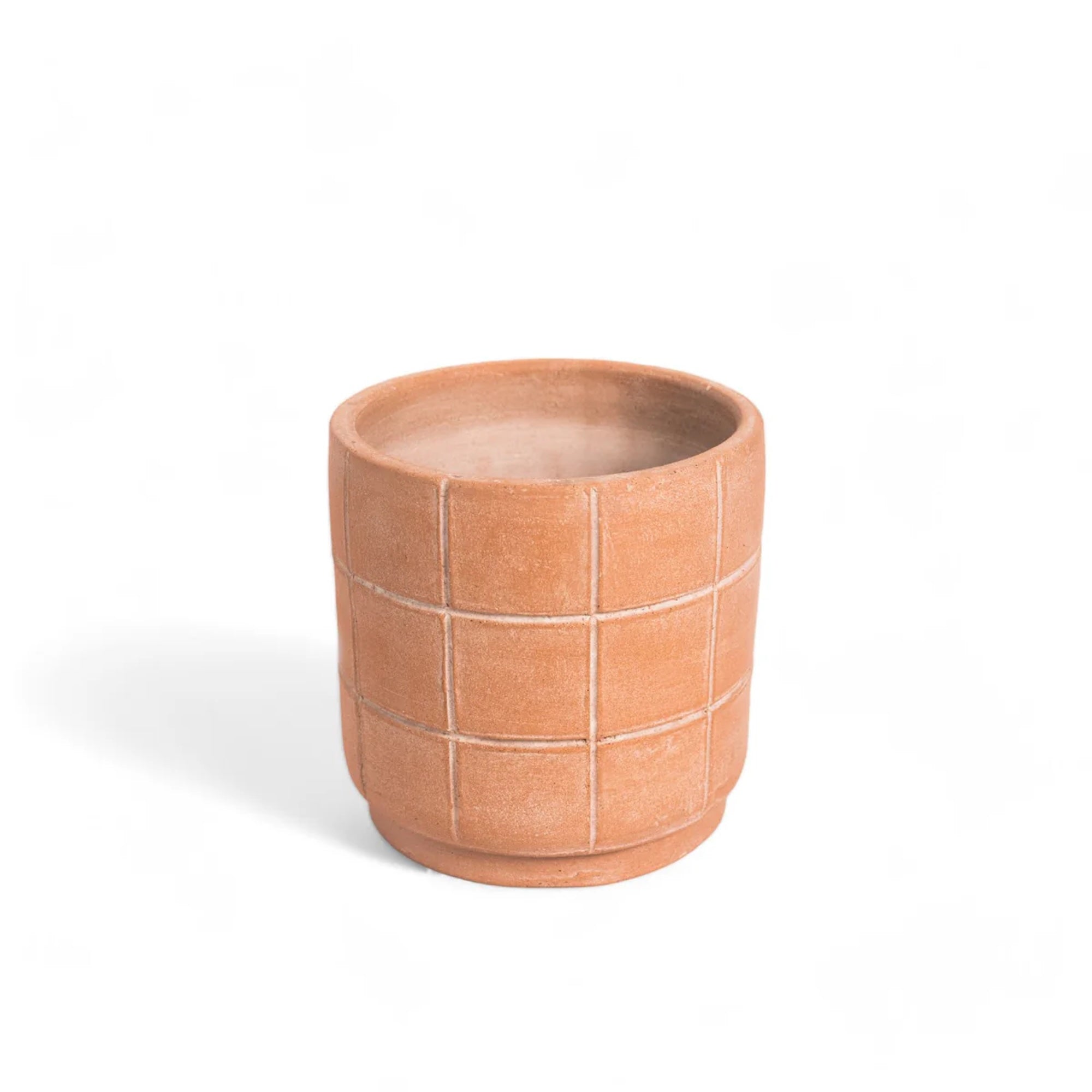 Round terracotta pot with grid pattern on white background