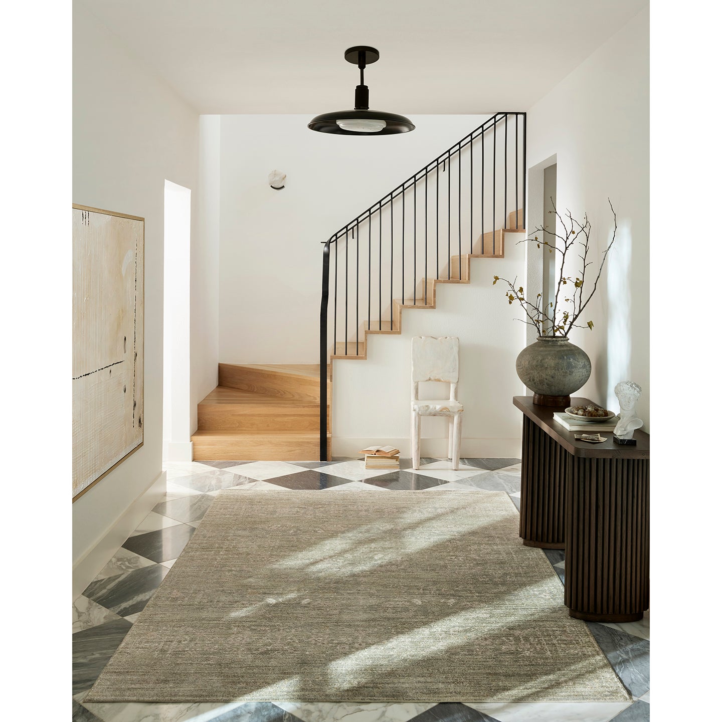 Modern interior with staircase, rug, and decorative elements