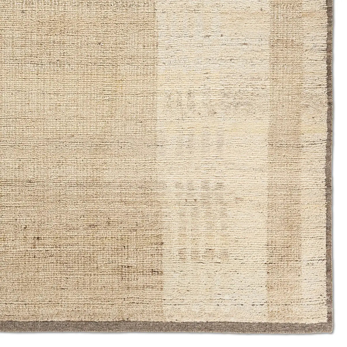Textured beige rug with a subtle pattern
