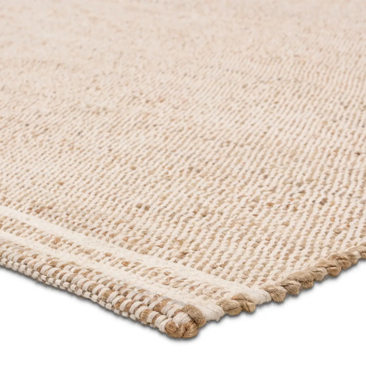 Close-up of a beige woven rug with a textured border.