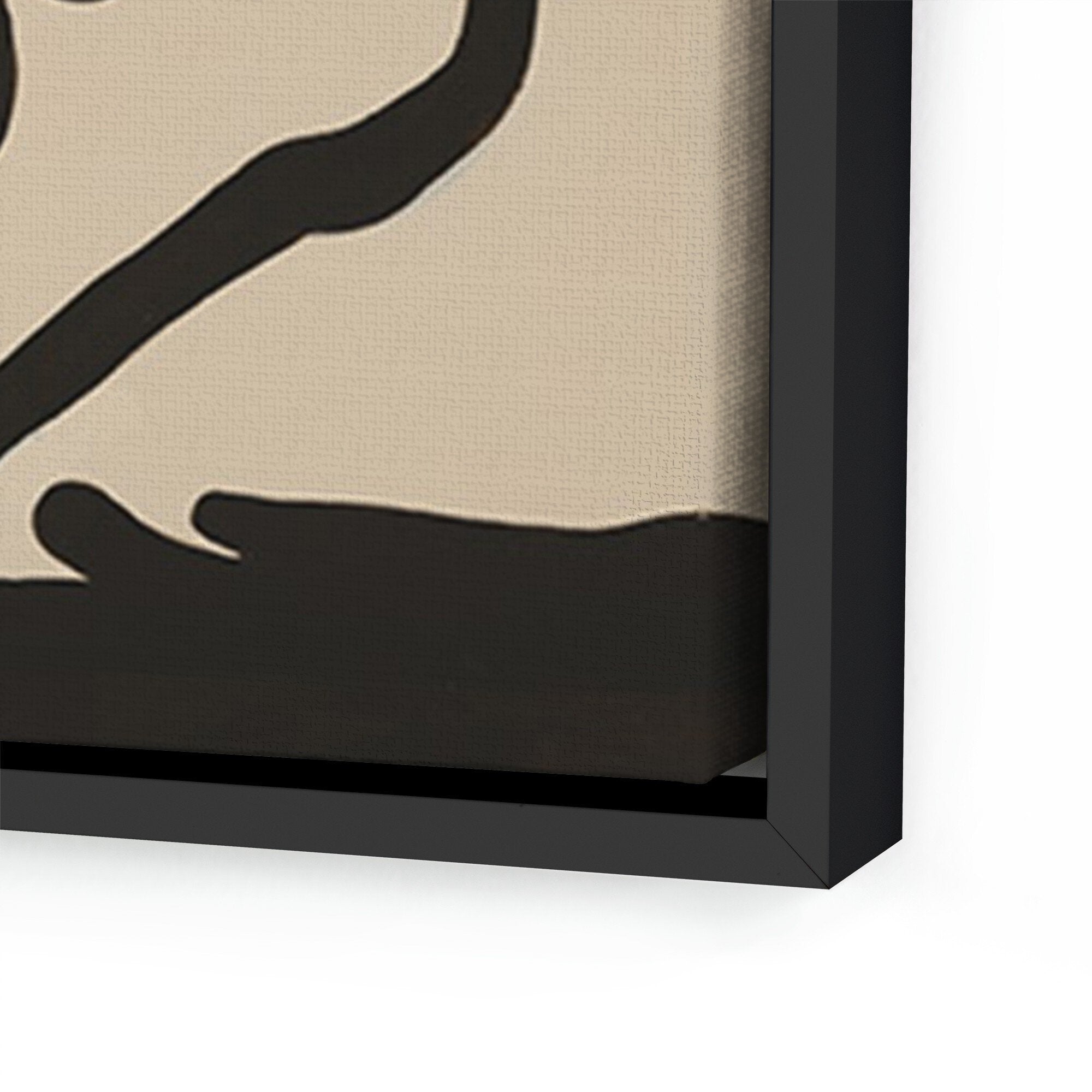 Close-up of a black framed artwork on a beige background