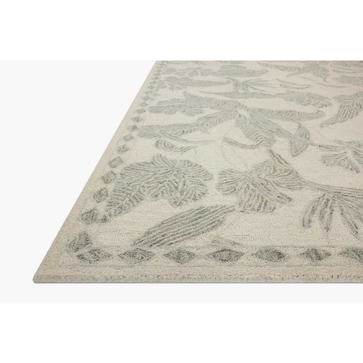 Textured rug with leaf pattern on a white background