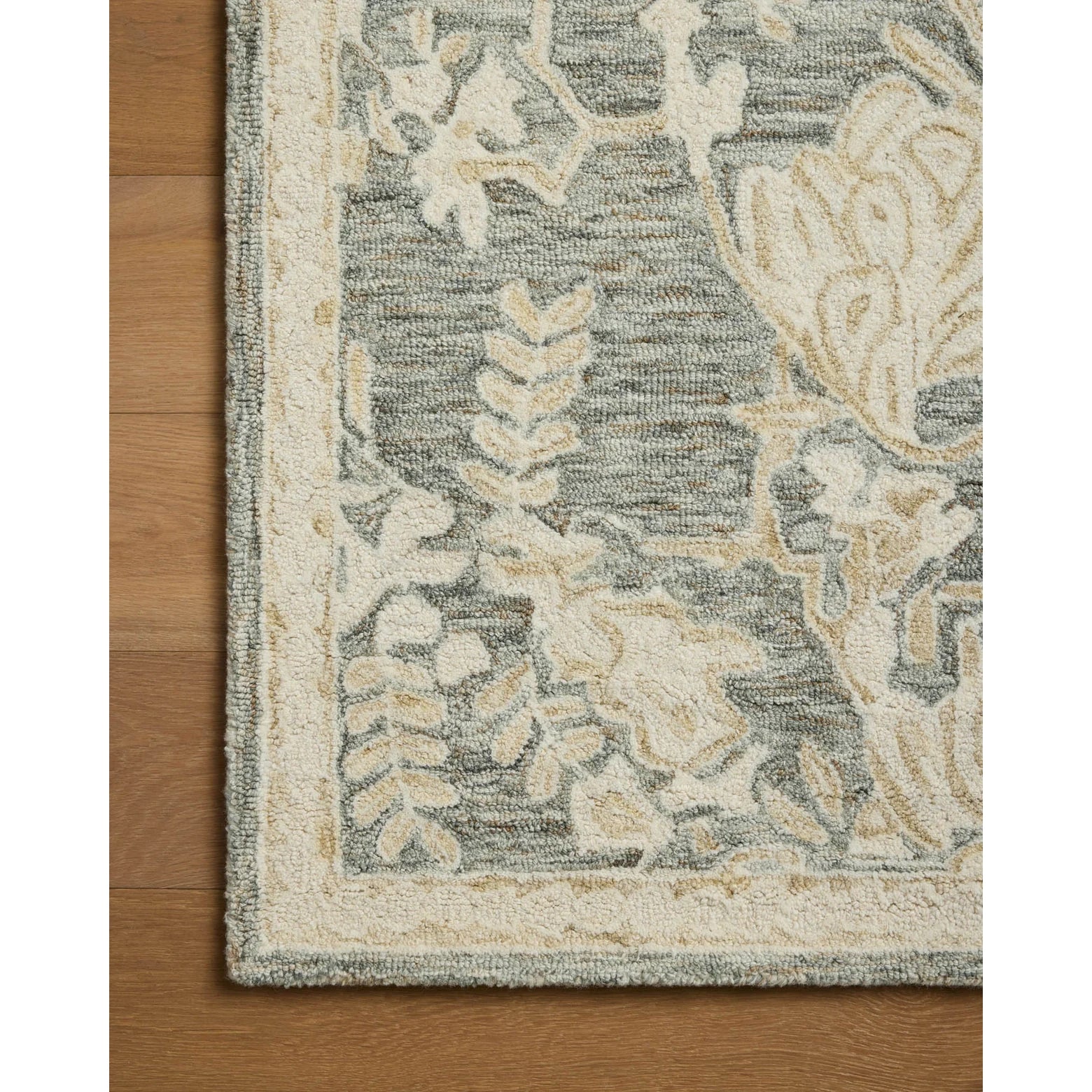 Decorative floral rug on a wooden floor