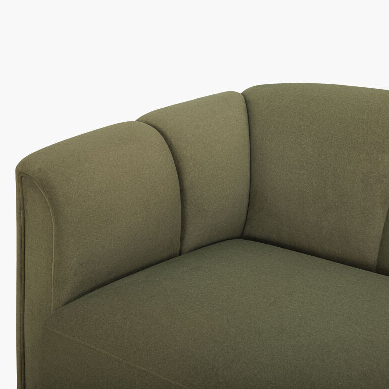 Close-up of an upholstered sofa corner in a muted olive green fabric, showing the armrest, back cushions, and seat against a plain white background.