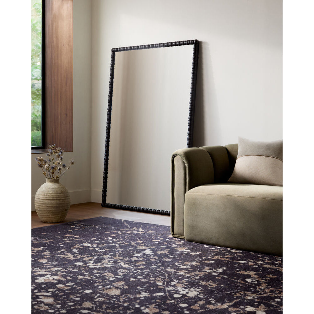 Room interior with a large mirror, sofa, and rug.