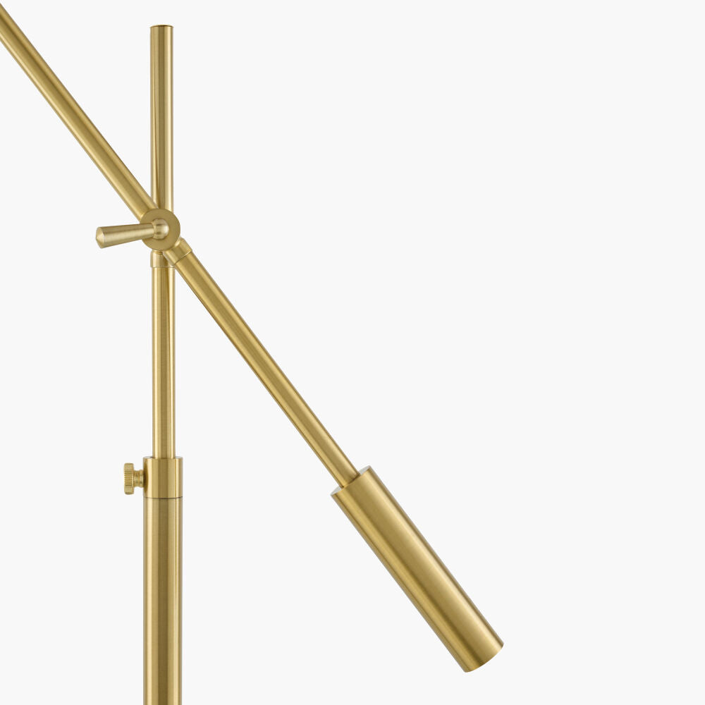 A close-up of a brushed gold metal lamp, showing the vertical post, adjustable slide bar on a plain white background.
