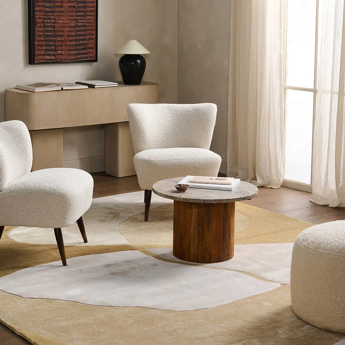 Modern living room with beige armchairs, a wooden coffee table, and a large window.