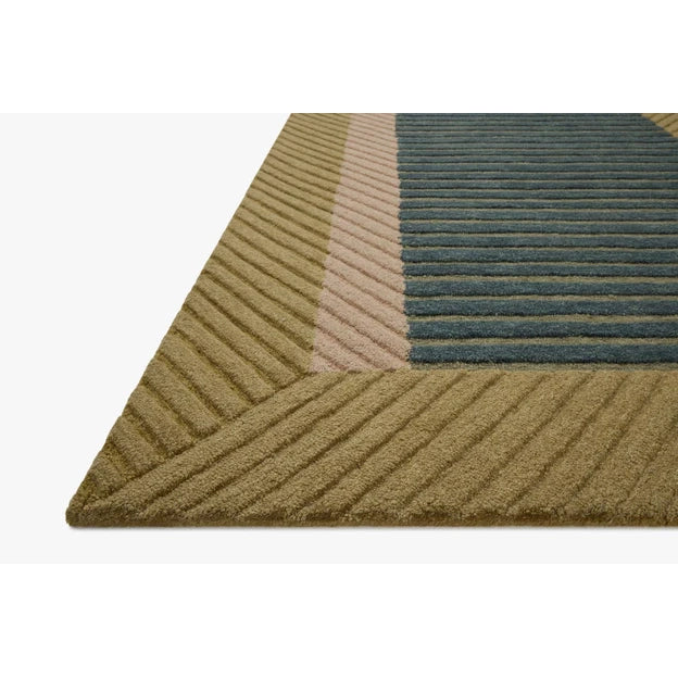 Geometric patterned rug with green and brown colors on a white background