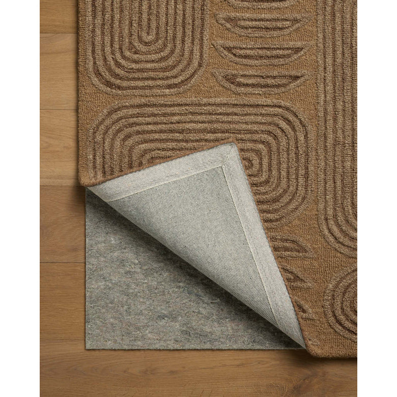Brown textured rug with a gray underlay on a wooden floor