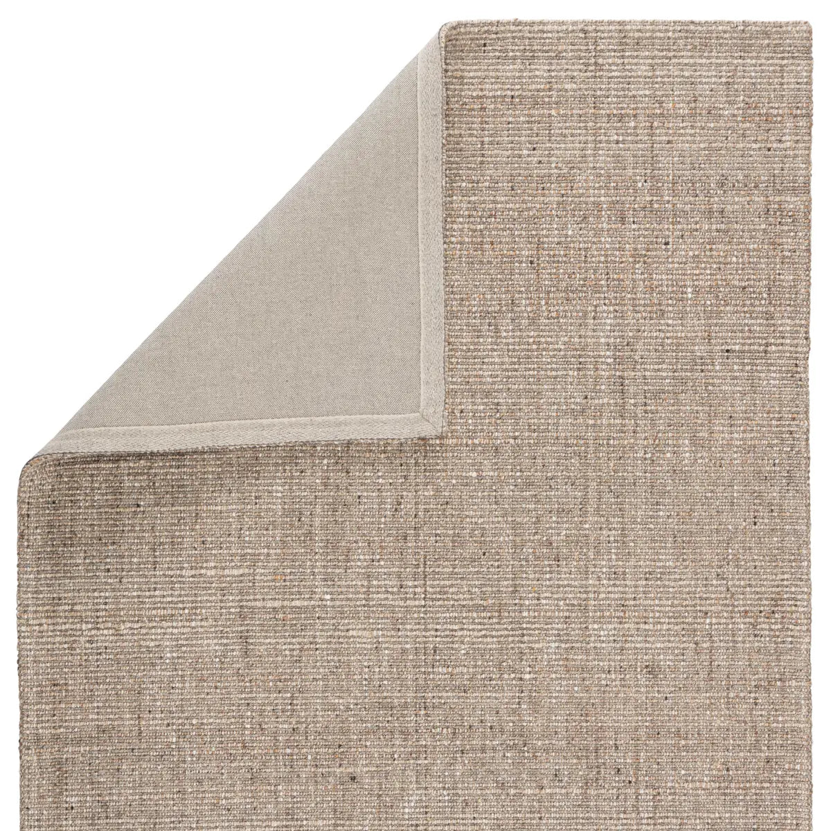 Textured beige rug corner on a white background
