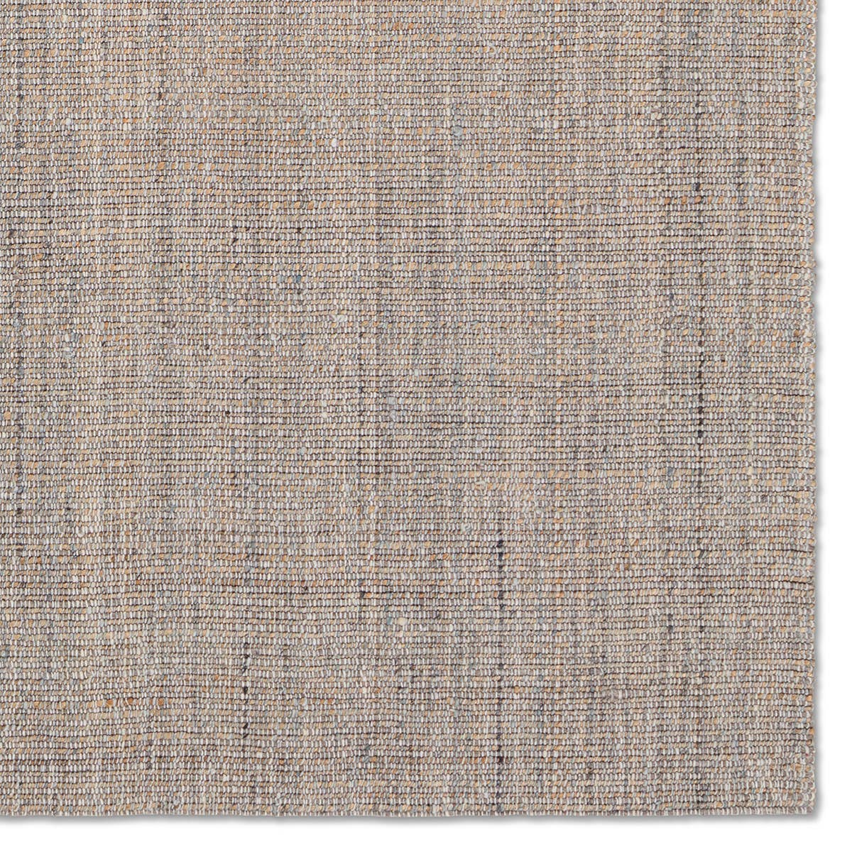 Textured beige rug with a subtle pattern on a white background