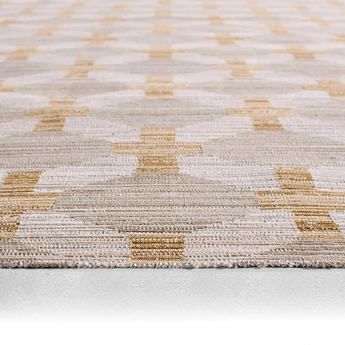 Close-up of a textured rug with geometric pattern on a light background