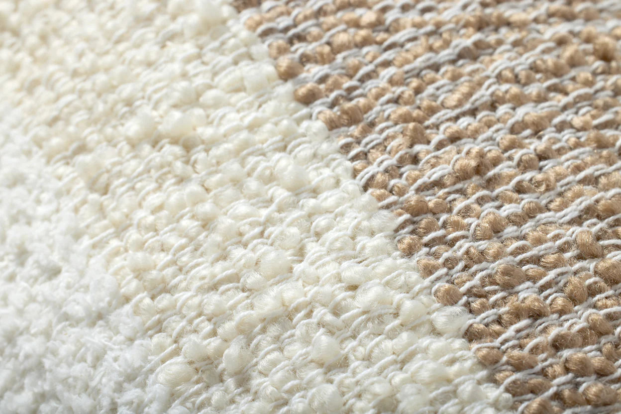 Close-up of a textured pillow with a mix of white and brown colors.