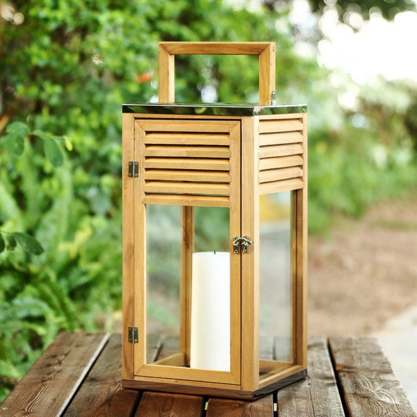 Wooden lantern with a candle on a wooden surface outdoors
