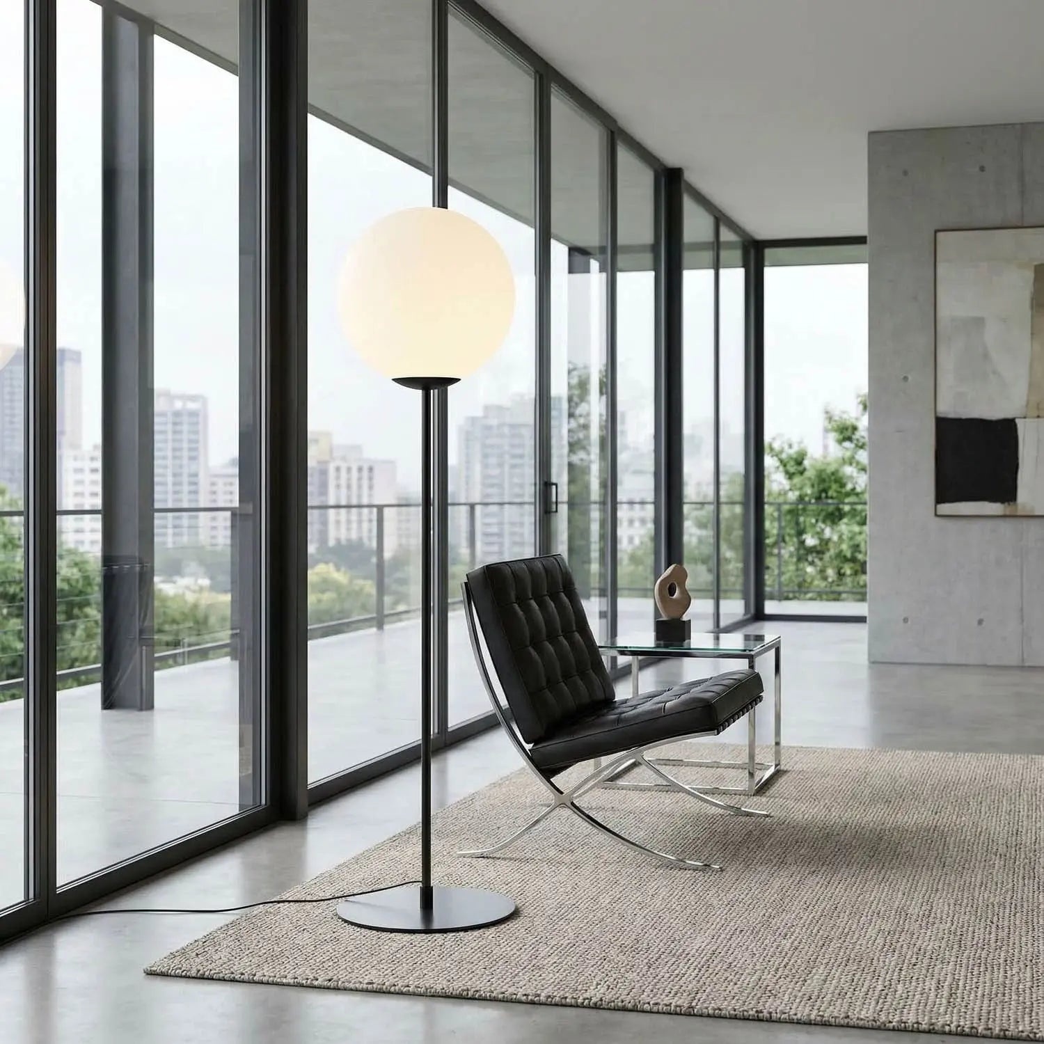 Modern interior with a black leather chair and floor lamp near large windows with a cityscape view.