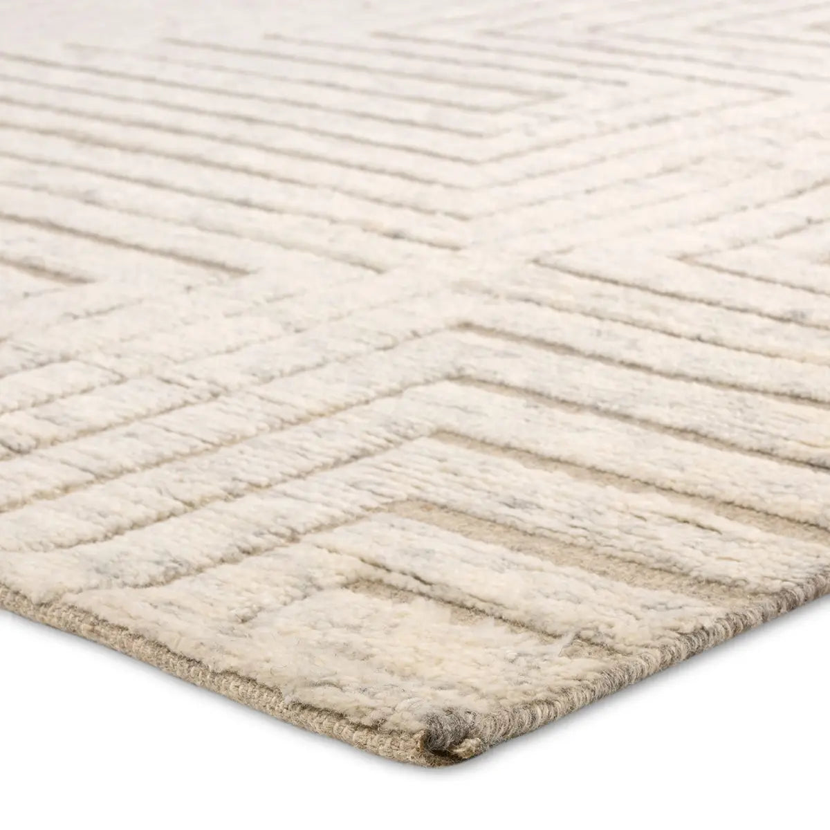 Textured beige rug with a geometric pattern on a white background