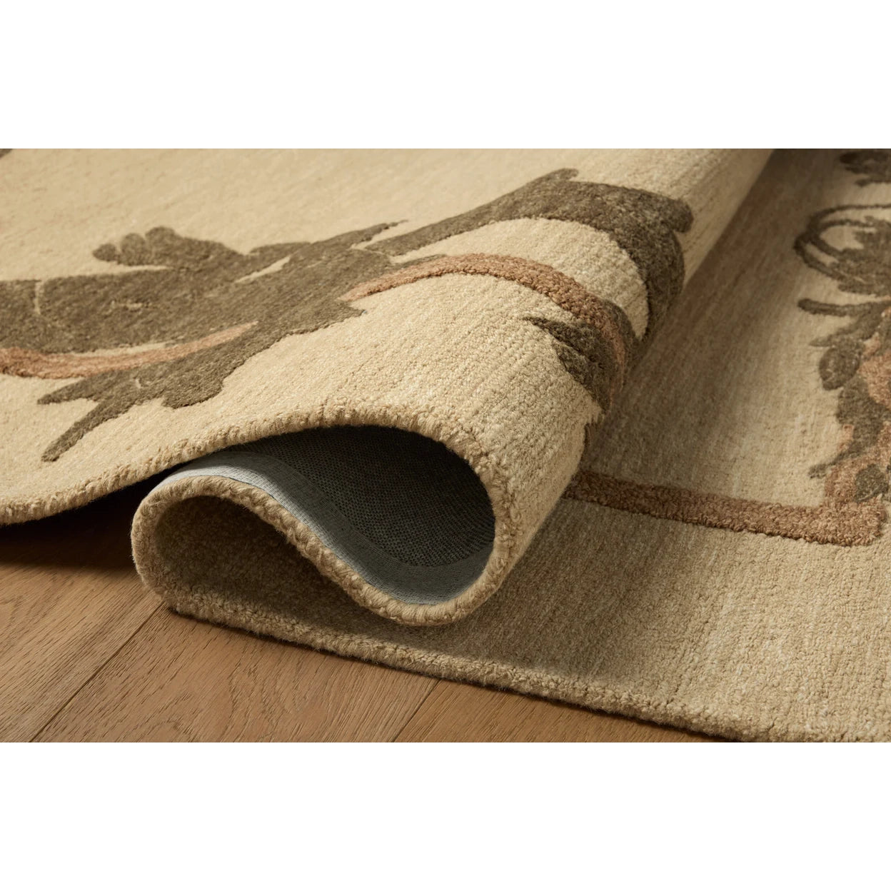 Close-up of a textured rug with a natural pattern on a wooden floor.