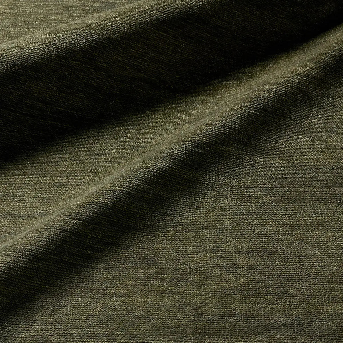 Close-up of dark green fabric with visible texture