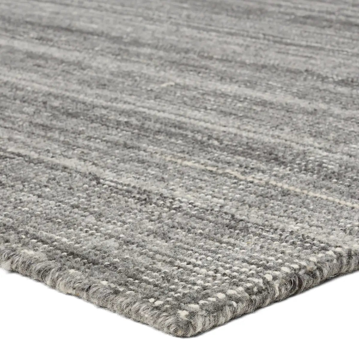 Close-up of a textured gray rug with a white background