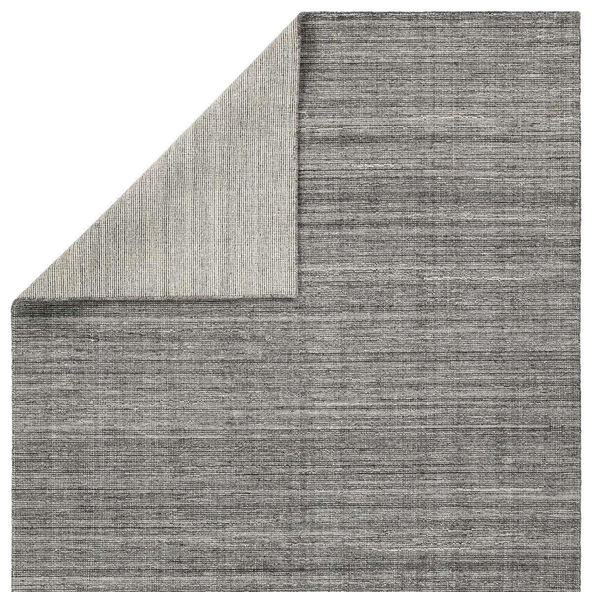 Gray textured rug corner on a white background