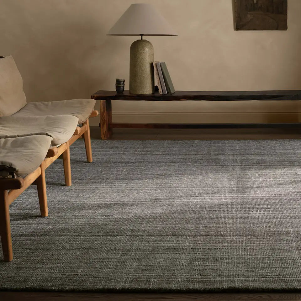 Grey hued rug in a contemporary room with beige walls