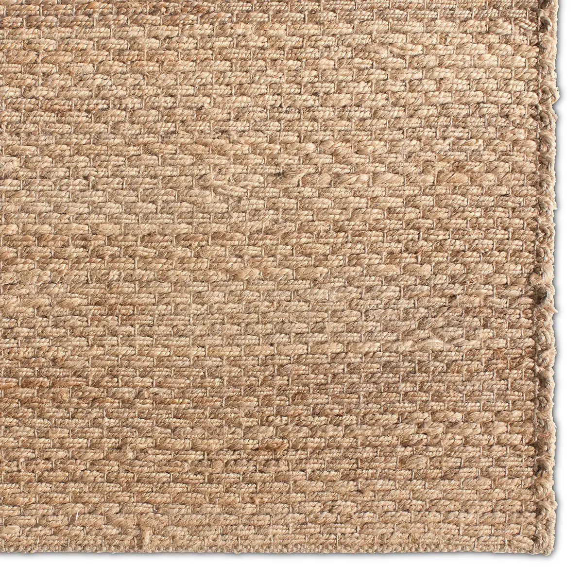 Close-up of a textured beige carpet corner