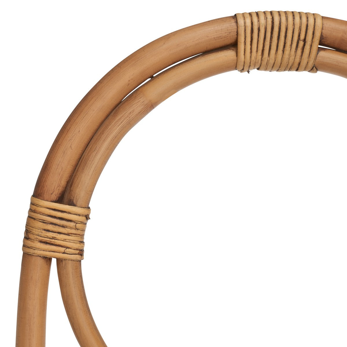 Close-up of a woven bamboo ring on a white background