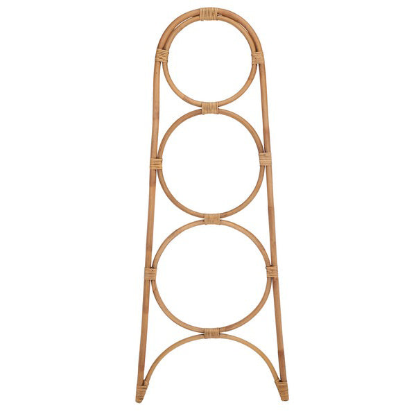 Rattan towel stand with circular design on a white background