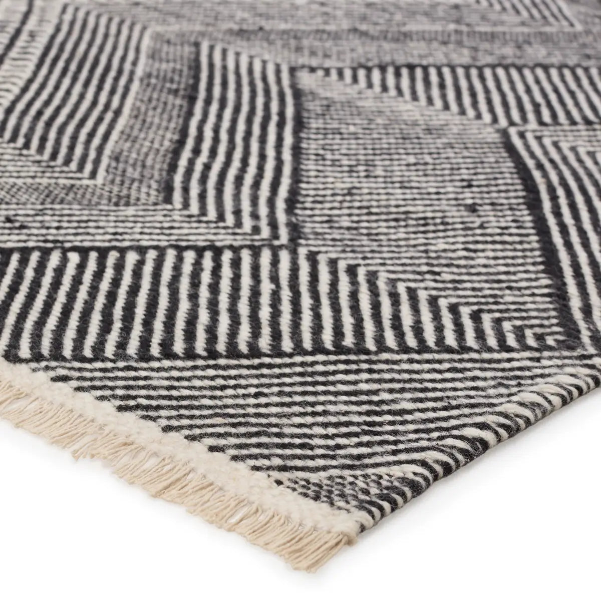 Textured rug with black and white pattern on a white background