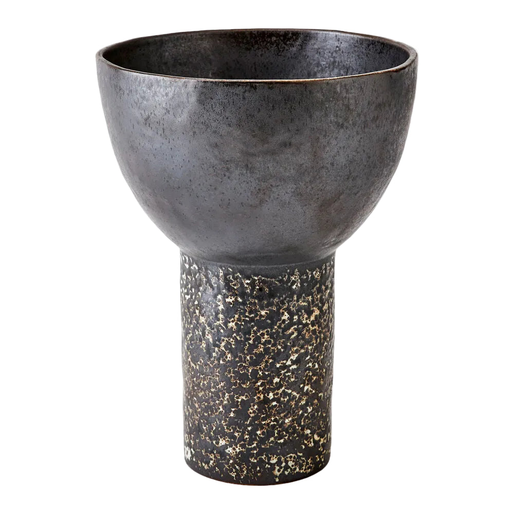 Decorative vase with textured design on a light gray background