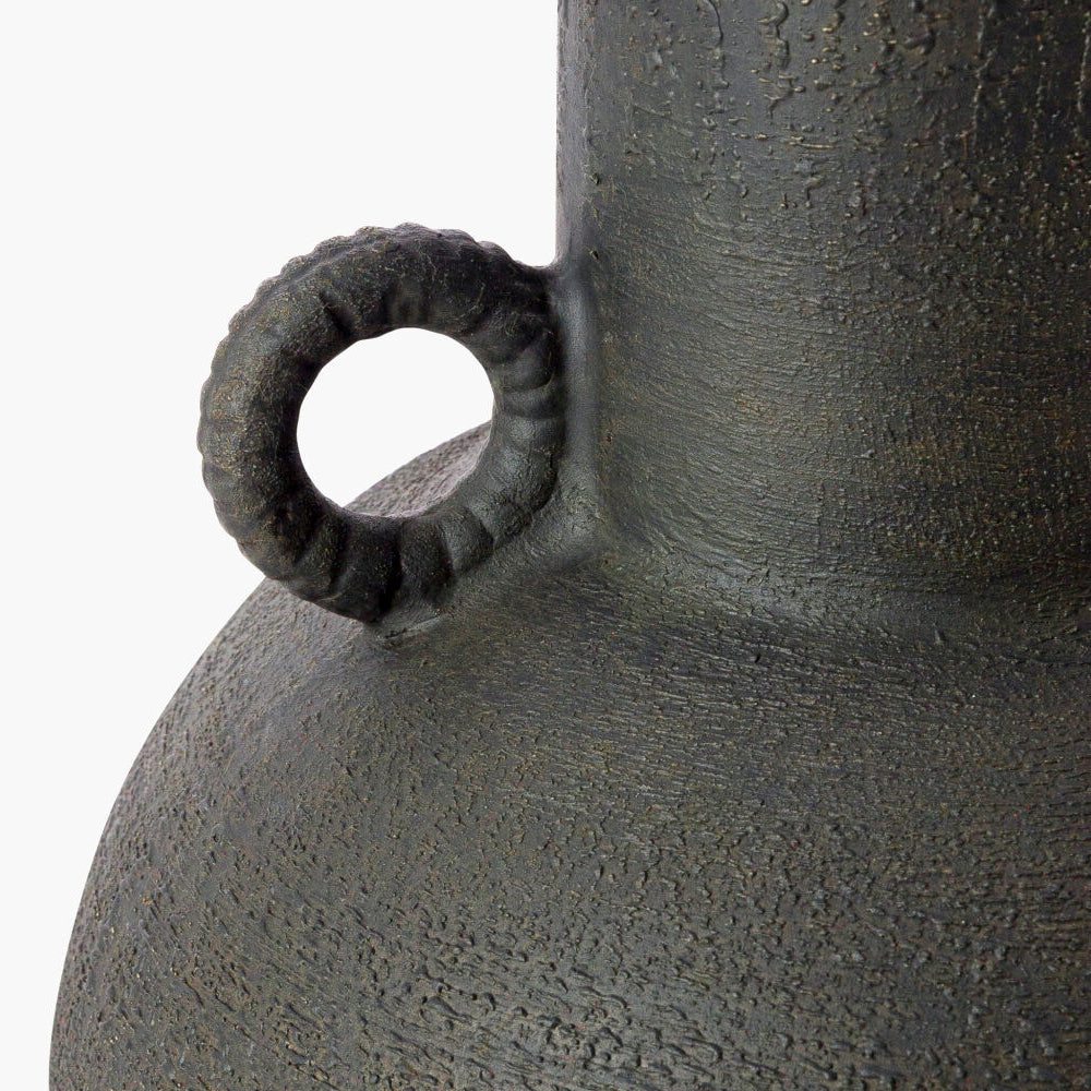 Close-up of a textured metal object with a circular detail on a white background