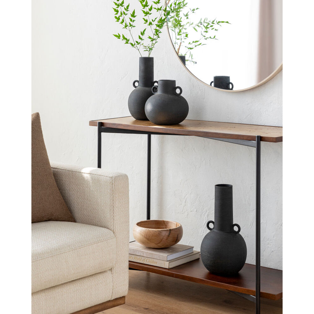 Wooden console table with black vases and a wooden bowl in a living room setting.