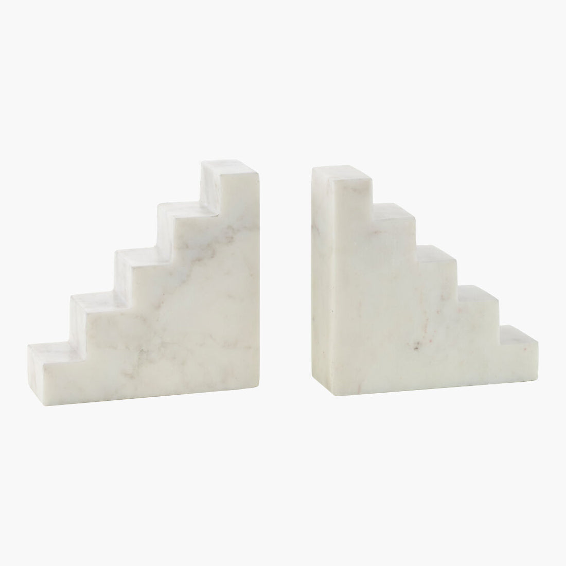 Two white marble bookends on a white background