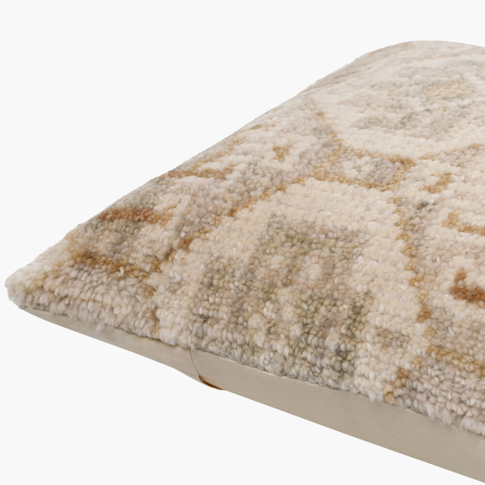Textured beige pillow on a white background