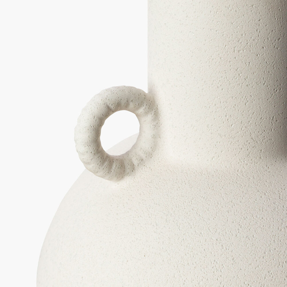 White textured vase with a circular handle on a white background