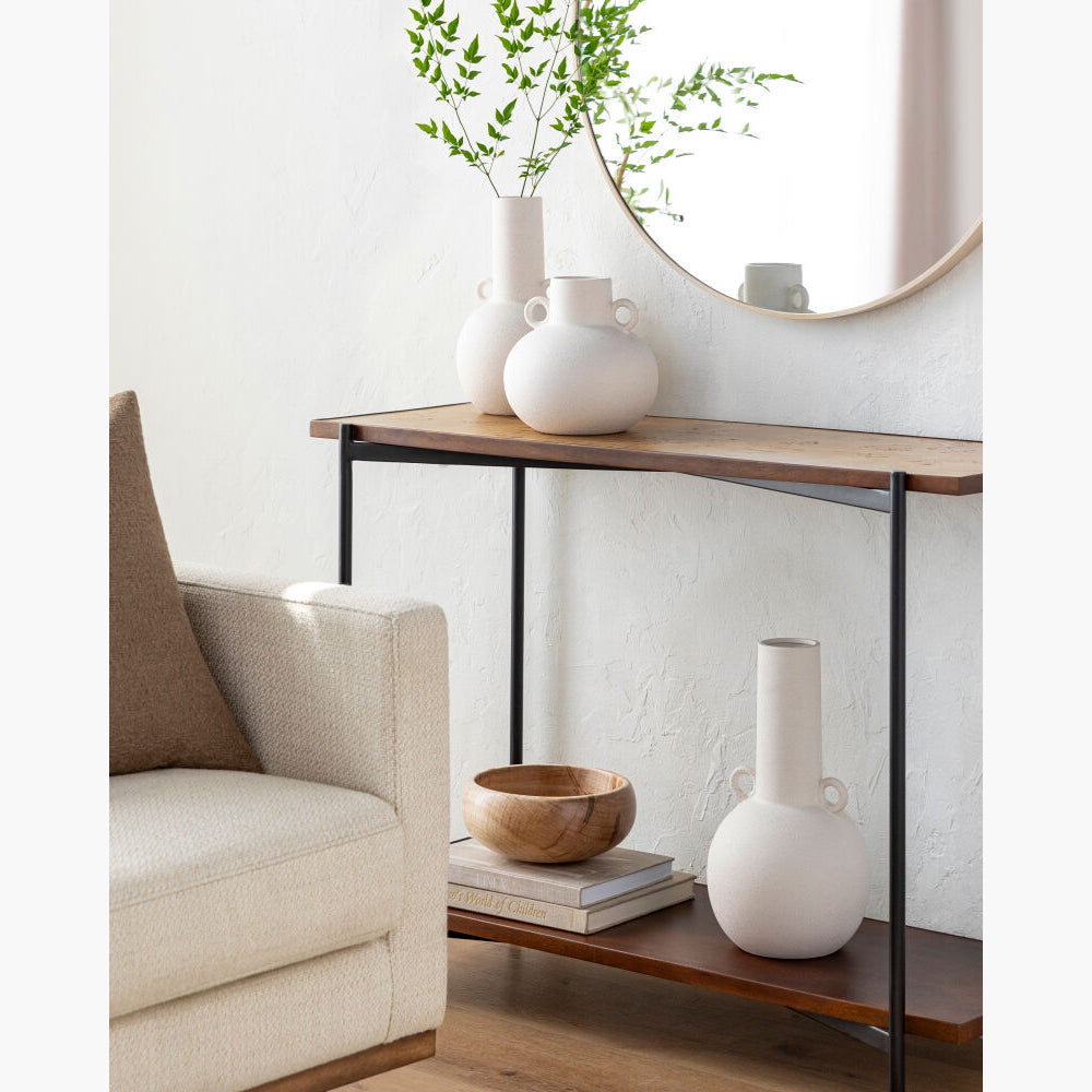 Console table with decorative items in a living room setting