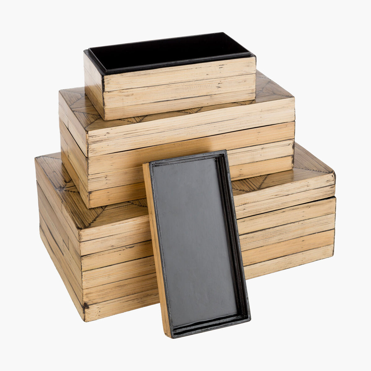 Stack of wooden boxes with black lids on a white background
