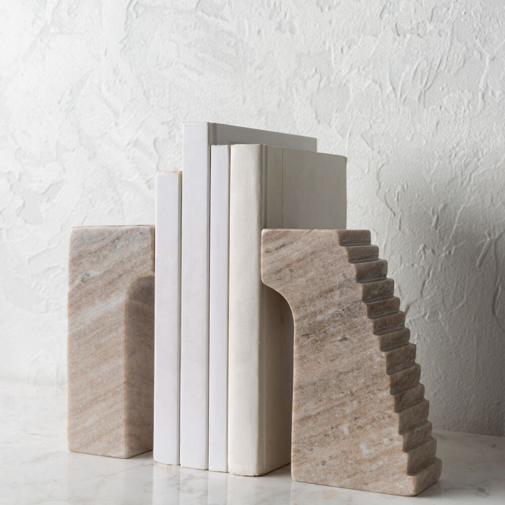 Stone bookends on a textured white surface