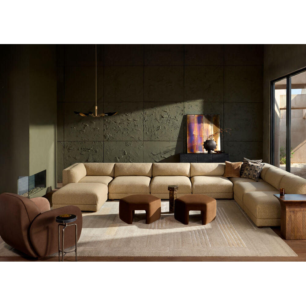 Modern living room with a beige sectional sofa, armchair, and coffee table.