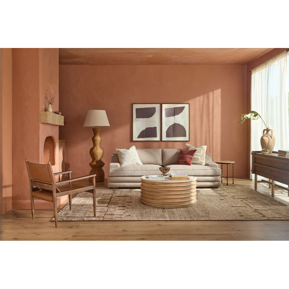 Living room with a gray sofa, wooden coffee table, and decorative items.