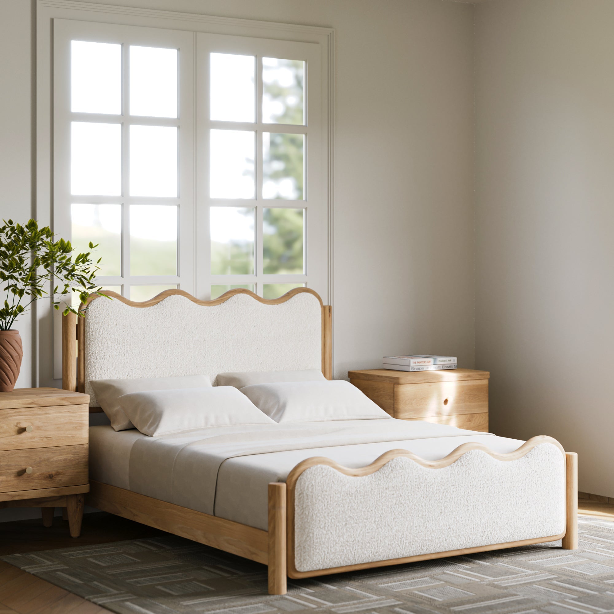 A light wood and cream upholstered bed frame with scalloped headboard and footboard, shown in a bright, modern bedroom setting with matching nightstands and a window.