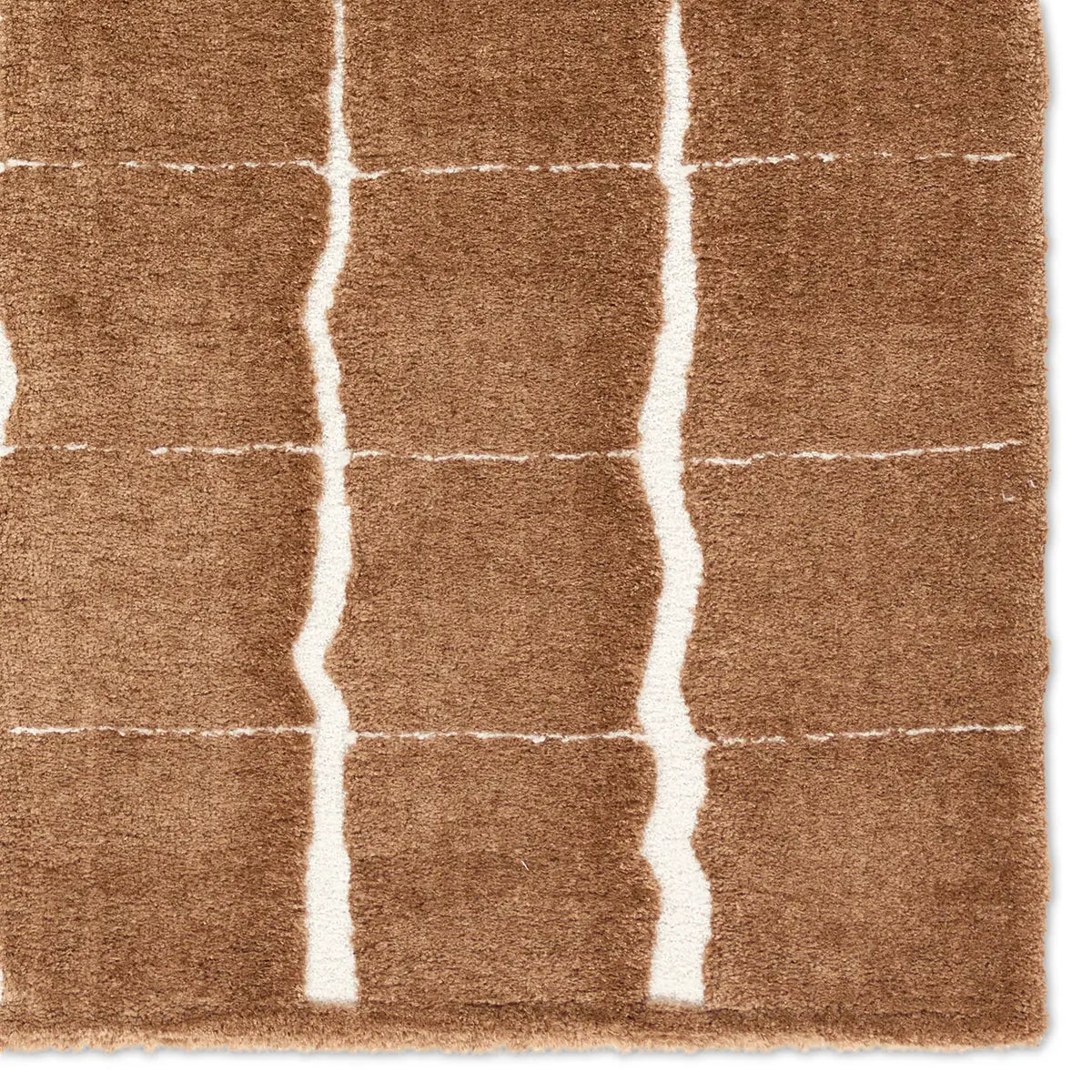 Brown rug with white geometric lines on a plain background
