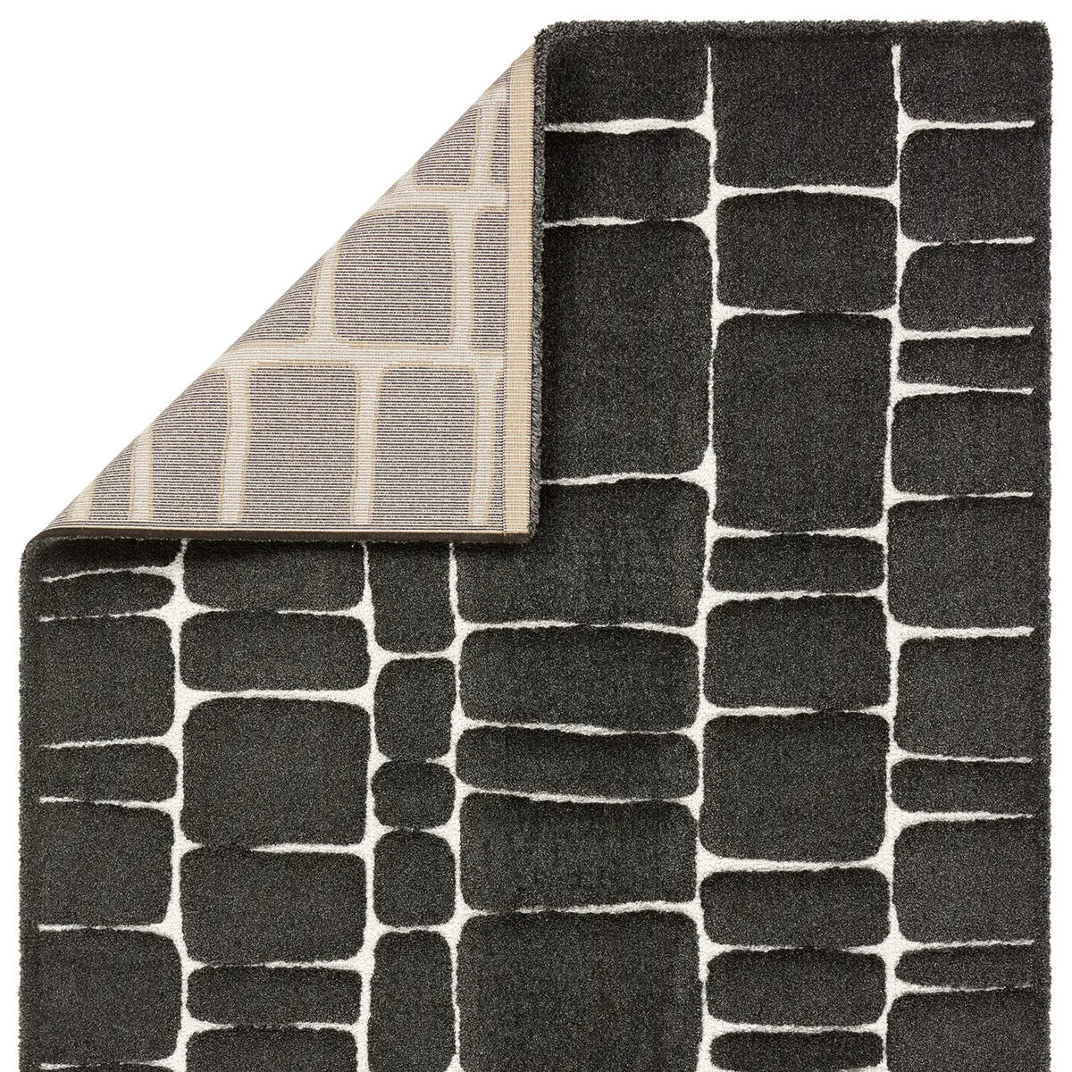 Black geometric patterned rug with a corner turned up to show texture