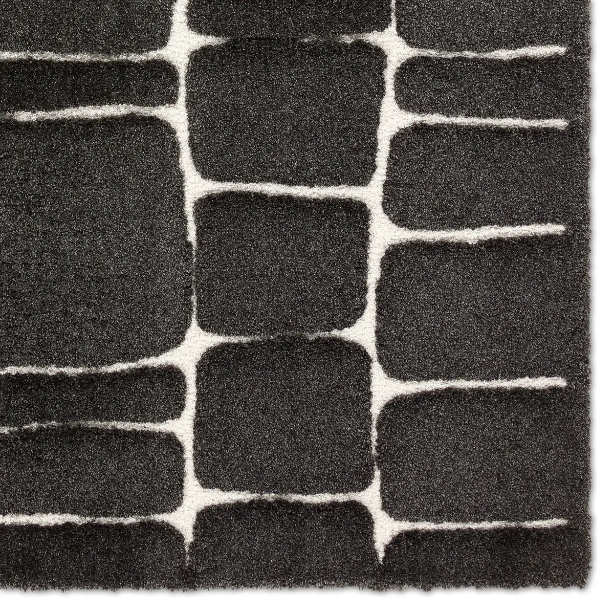 Close-up of a textured black and white rug with geometric pattern
